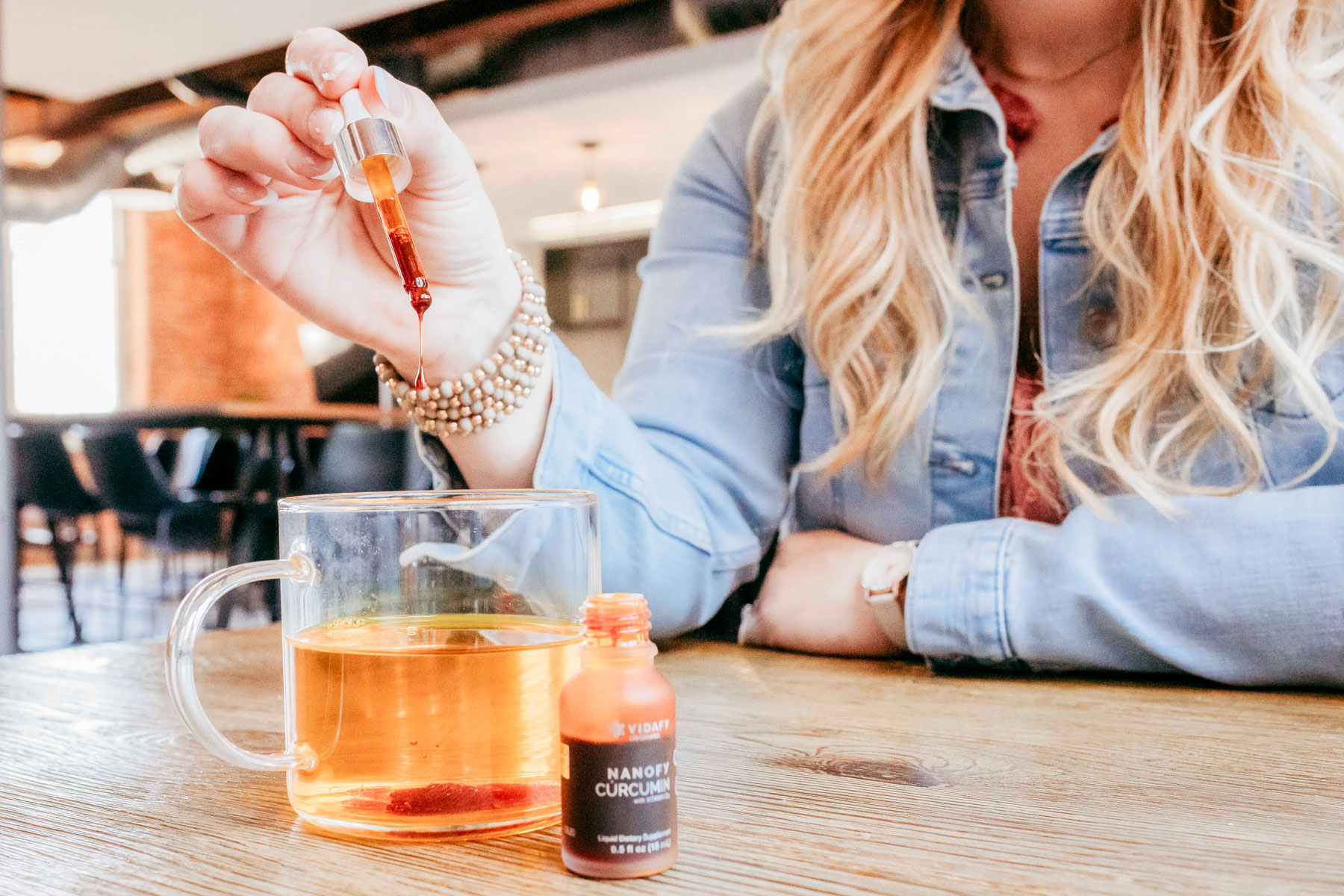 Adding Nanofy drops to morning tea
